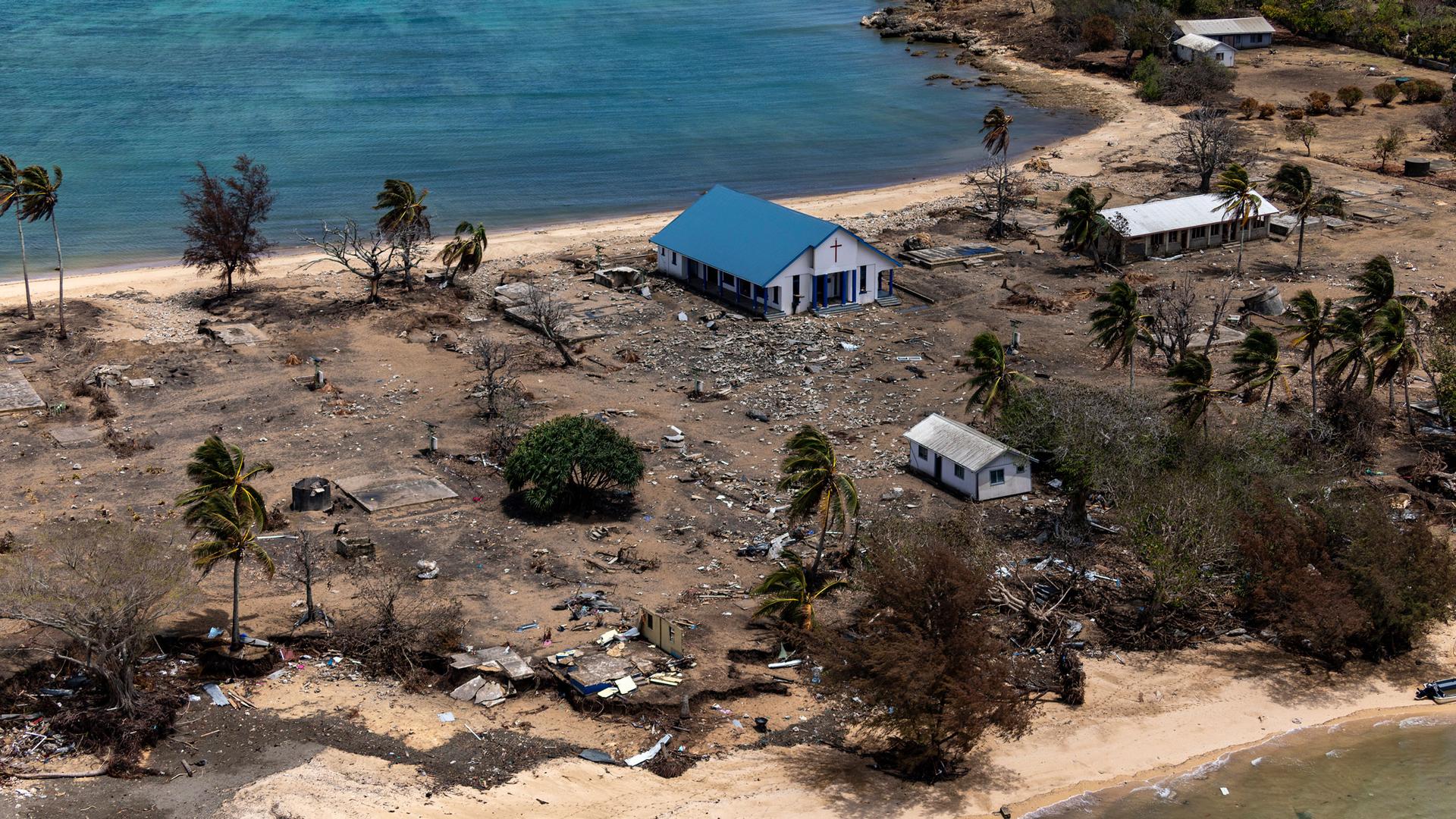 In this photo provided by the Australian Defense Force, debris from damaged building and trees are strewn around on Atata Island in Tonga, on Jan. 28, 2022.
