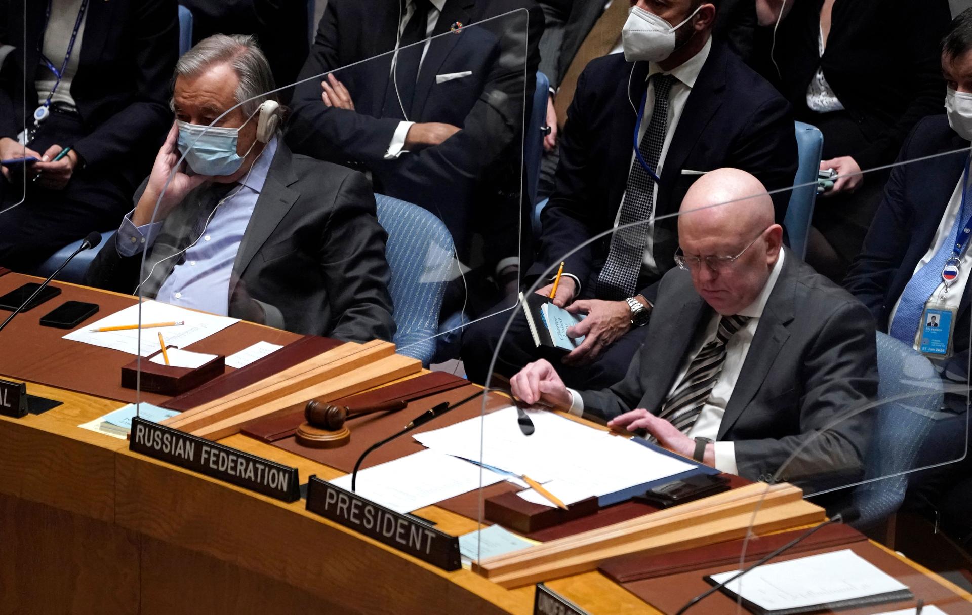 U.N. Secretary-General Antonio Guterres, left, sits next to Russian ambassador Vasily Nebenzya during an emergency U.N. Security Council meeting on Ukraine on Feb. 23, 2022.