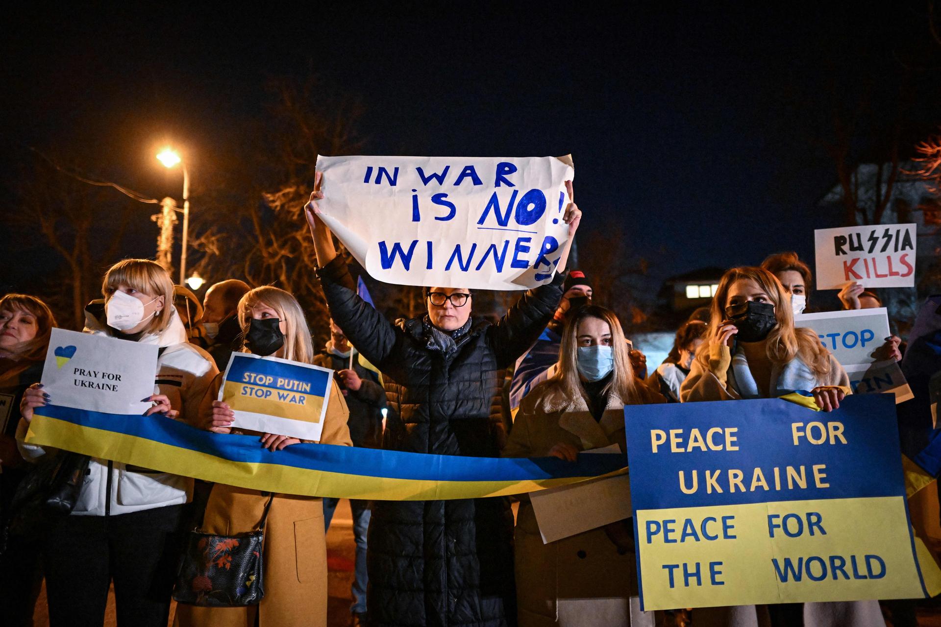 People protest in front of Ukraine’s embassy to Romania in Bucharest on Feb. 24, 2022. 