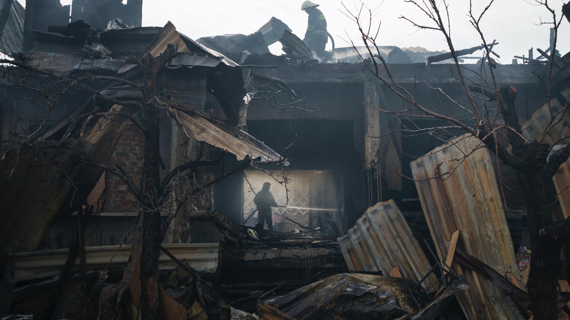 Firefighters work to extinguish a fire at a house after a Russian attack in Kharkiv, Ukraine, April 11, 2022. 