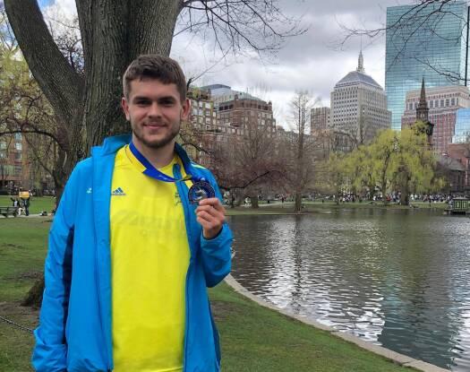 Eugen Godun stands after completing the Boston Marathon in 2019