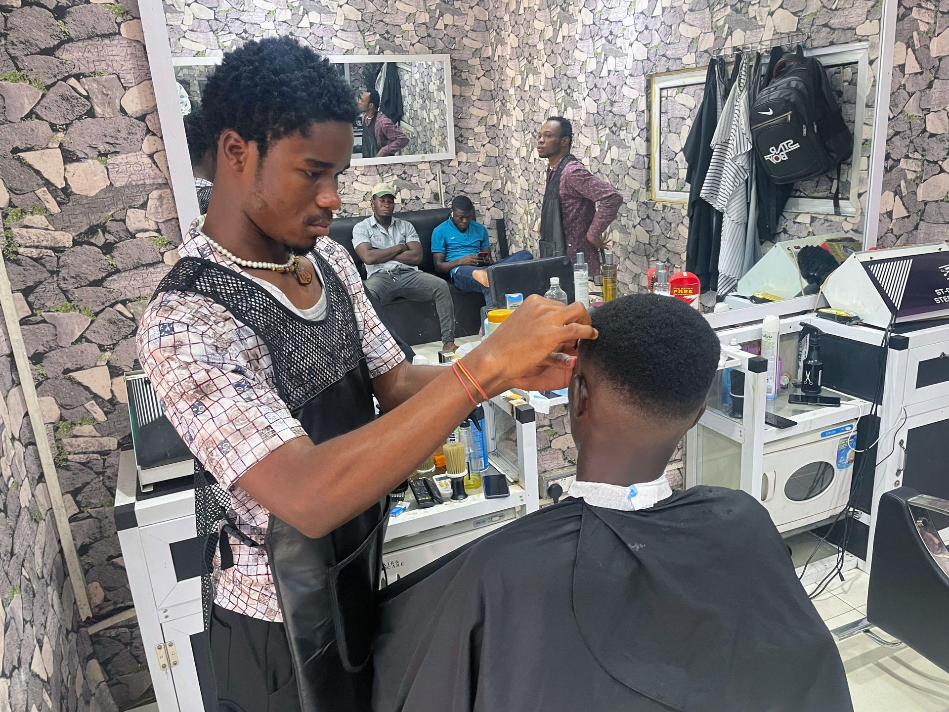 Daniel Fosu says his sales are dwindling becuase clients can't afford the transport costs to get to his barber shop.