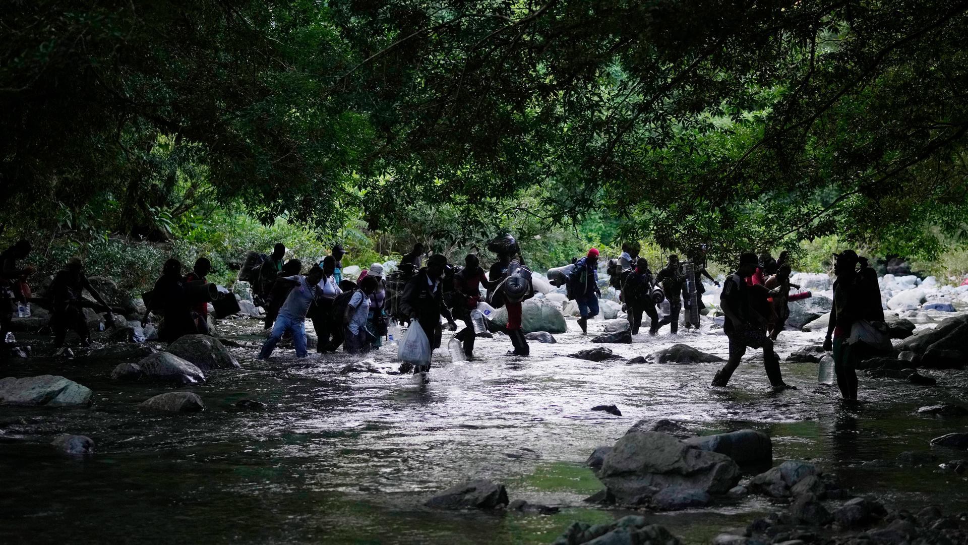 Migrants cross the Acandi River on their journey north, near Acandi, Colombia, on Sept. 15, 2021. 