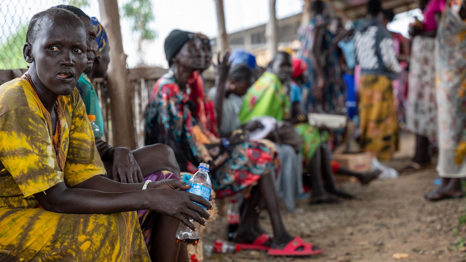 Internally displaced people form a line at a food distribution center at a camp for displaced people in Juba, South Sudan.