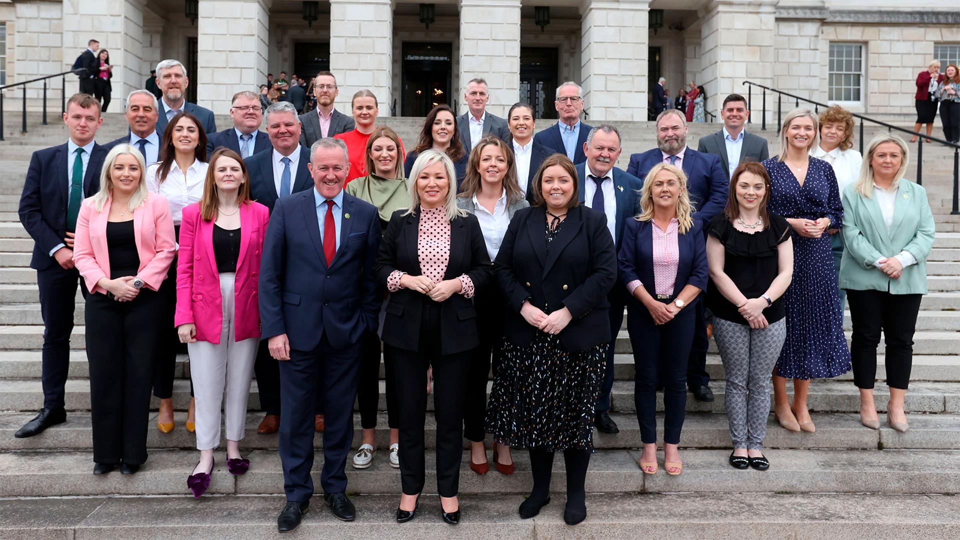 Irish nationalist party Sinn Fein's Michelle O'Neill, center, poses for a family photo with her party's newly elected members of the legislative assembly outside Parliament Buildings at Stormont, Belfast, Northern Ireland