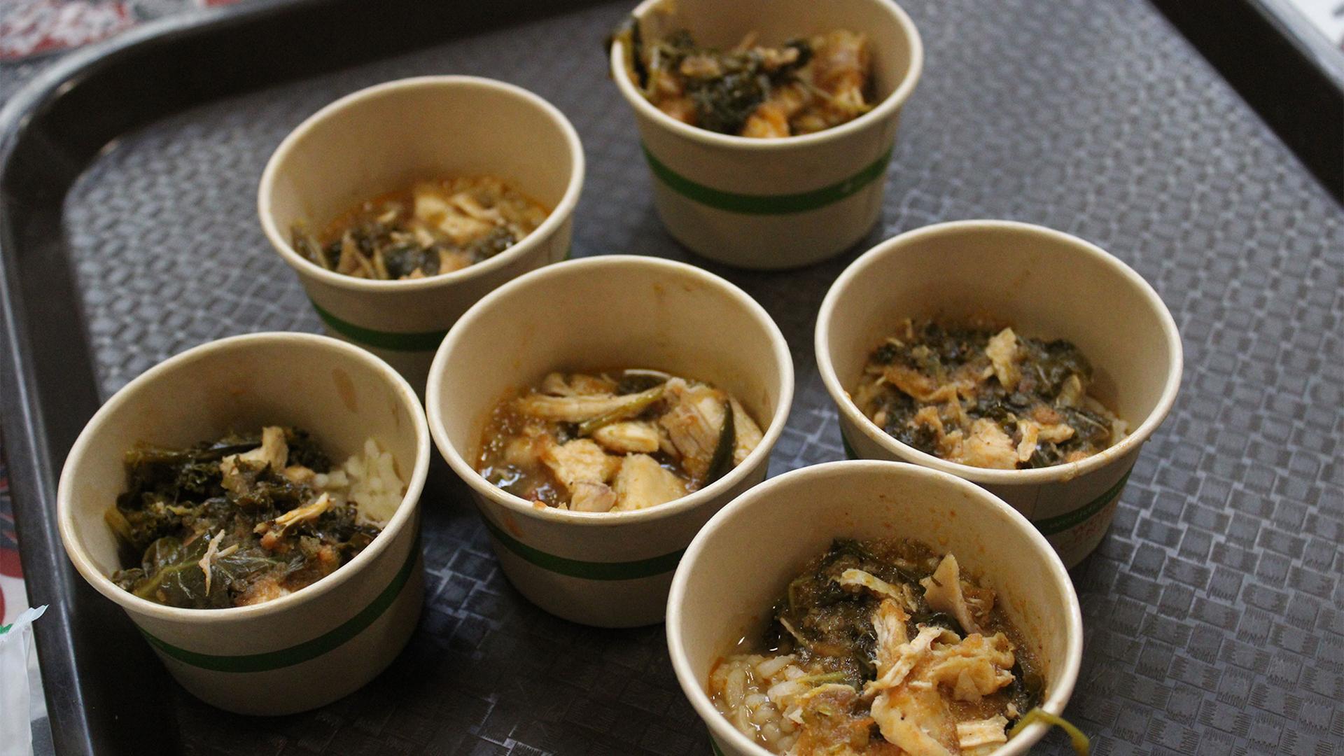 Sample portions of chicken and kale stew over rice