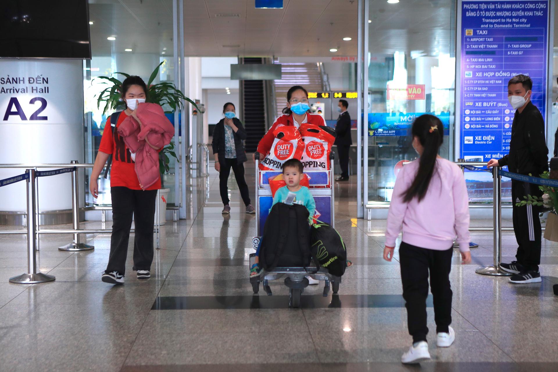 Vietnamese nationals arrive at the Hanoi airport after fleeing Ukraine on March 8, 2022.