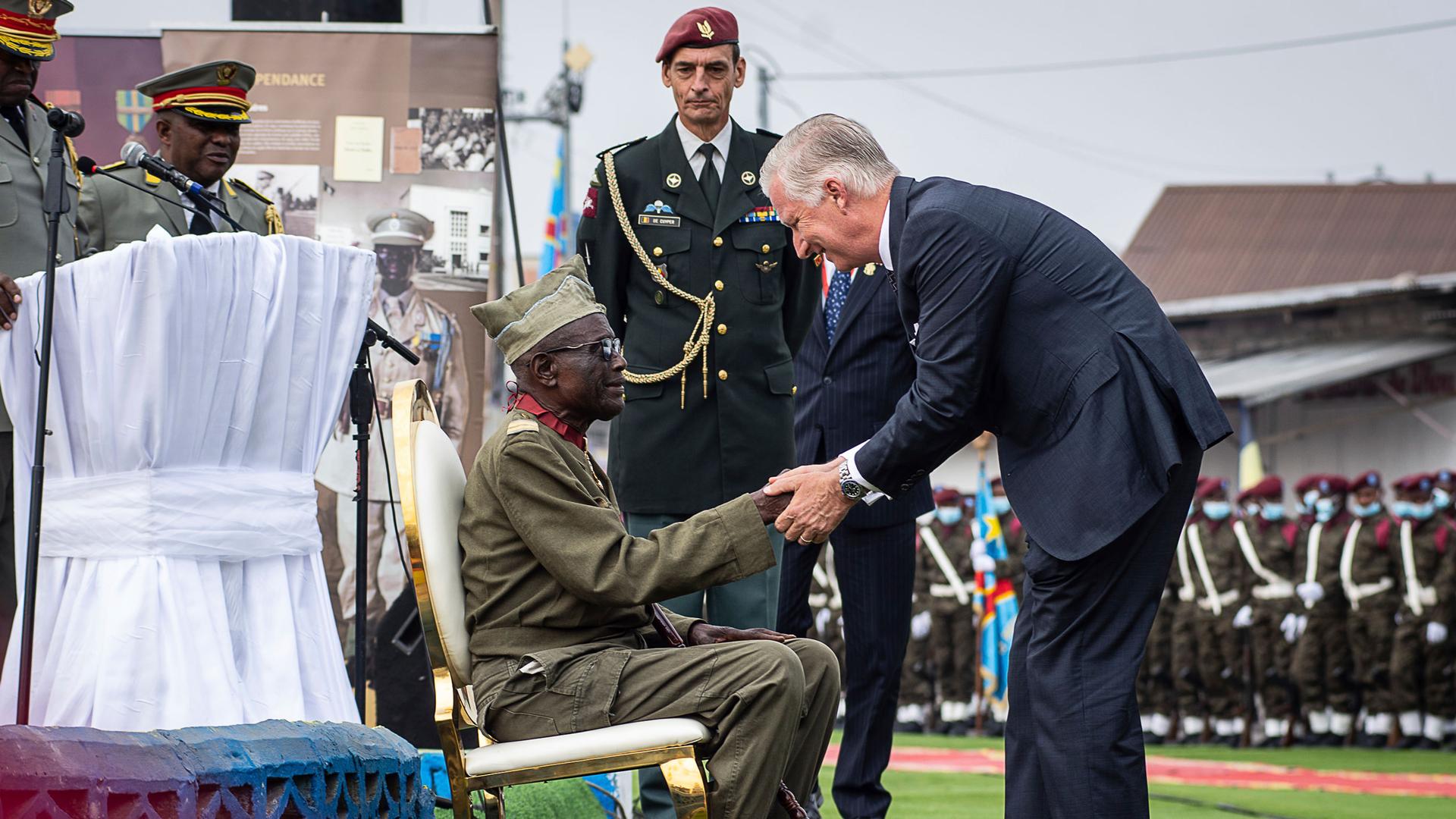 King Philippe of Belgium, right, greets 100-year-old corporal Albert Kunyuku, the last surviving Congolese veteran of World War II during a ceremony at the Veterans Memorial in Kinshasa, Democratic Republic of Congo, Wednesday June 8, 2022. 