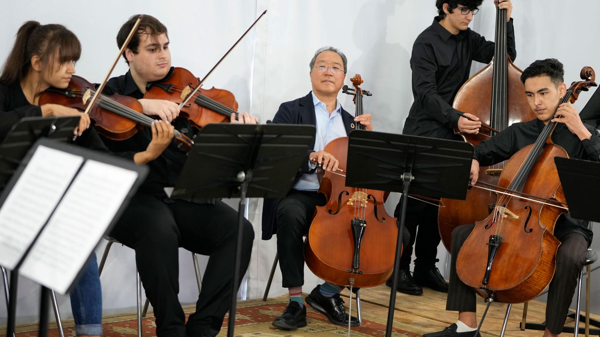 World renowned US cellist Yo-Yo Ma, center, plays with viola players Marzia Anwari, left, from Afghanistan and Luis Fernandes, bassist Eduardo Santos and cellist Mohammad Sami, right, from Afghanistan, at the Music School of the National Conservatory in L