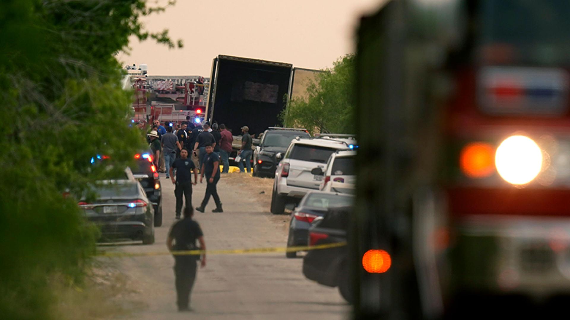 Body bags lie at the scene where a tractor trailer with multiple dead bodies was discovered, in San Antonio, Texas