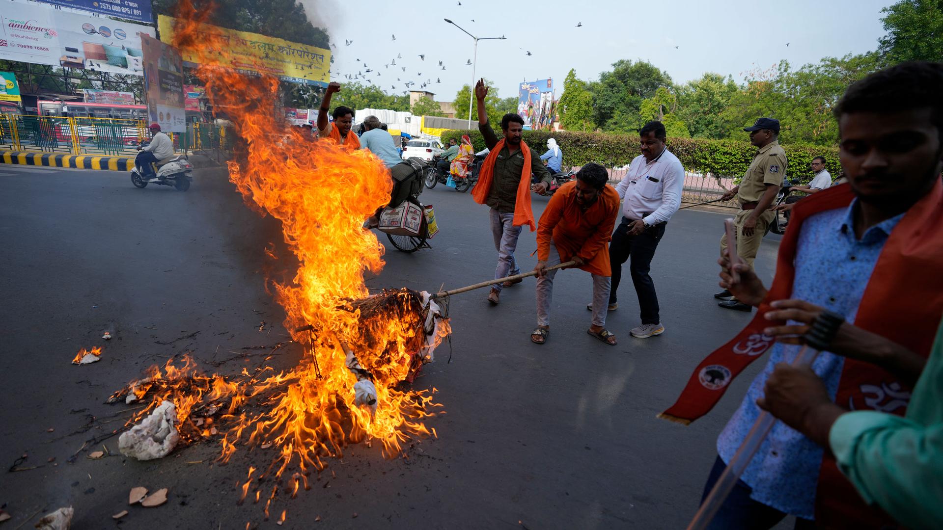Activists from right-wing Hindu organization Bajrang Dal burn an effigy of Islamic terrorism during a protest against the Tuesday killing of Kanhaiya Lal, a Hindu man in a suspected religious attack in western Udaipur city of Rajasthan state, in Ahmedabad