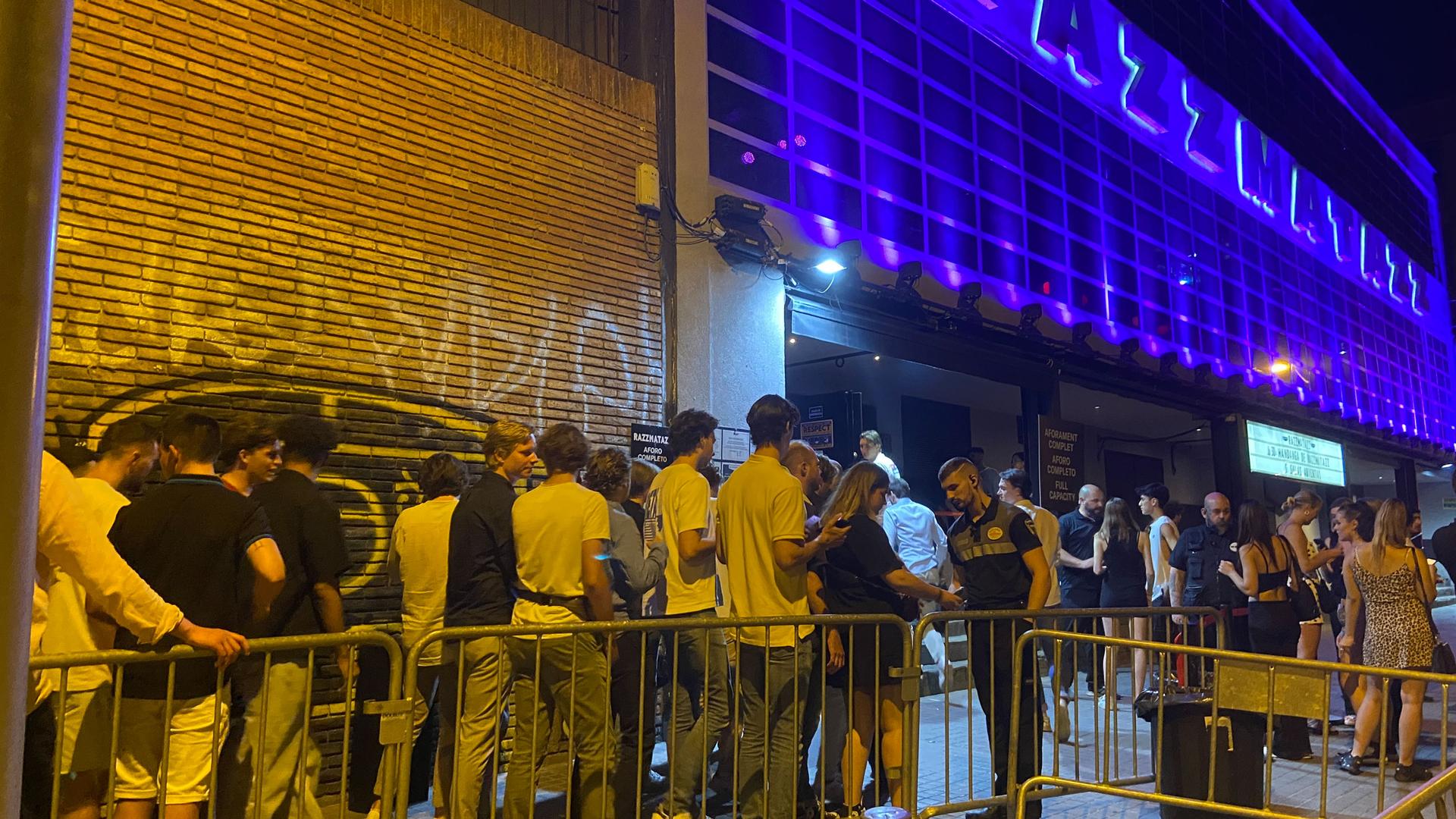 Hundreds of young people line up outside the Razzmatazz disco in Barcelona. Security guards are constantly on the look out for men trying to take advantage of inebriated women.