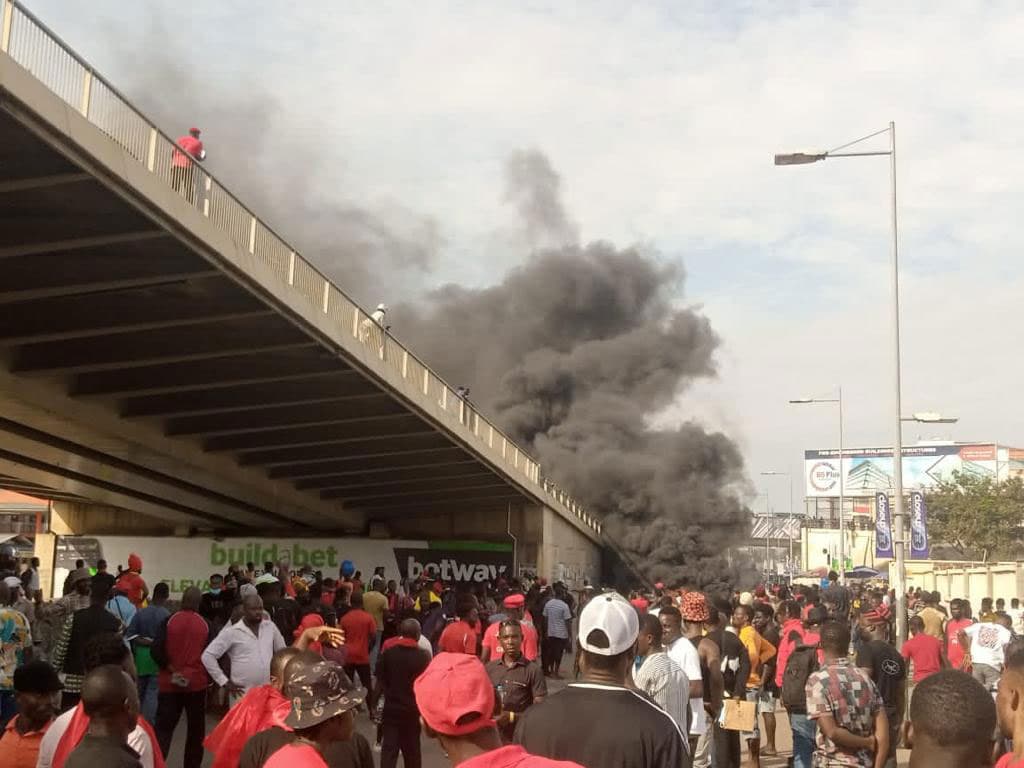A plume of black smoke billows as protesters burned car tires amid a protest against soaring costs of living in Ghana.