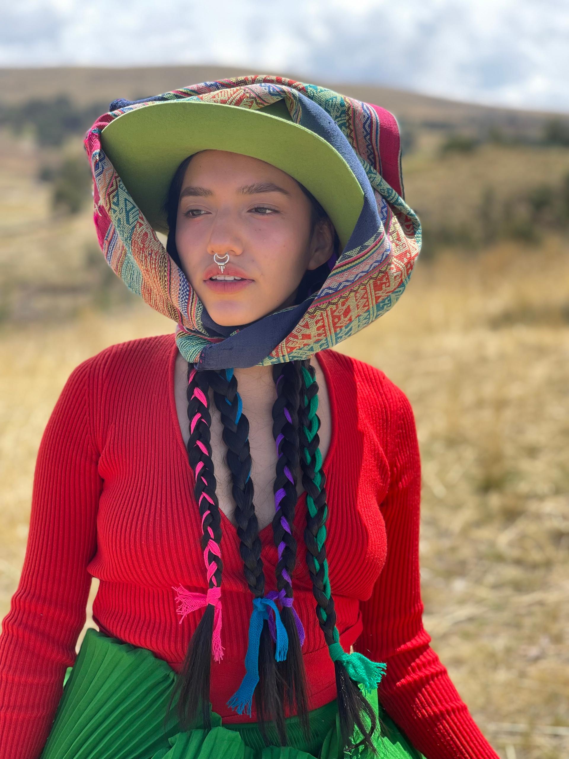 Renata Flores performs wearing traditional Quechua clothes.