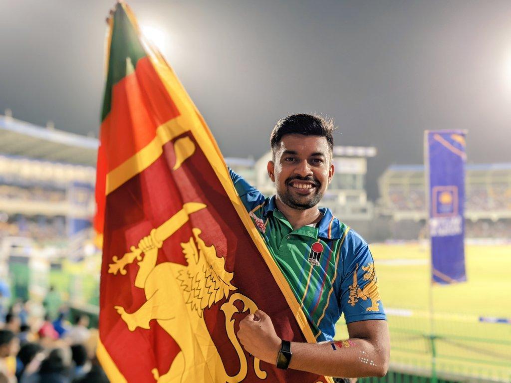 A cricket fan holds the Sri Lankan flag during a match with Australia in Colombo.