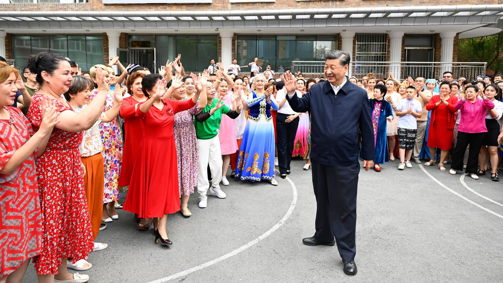 In this photo released by China's Xinhua News Agency, Chinese President Xi Jinping, center, visits the community of Guyuanxiang in the Tianshan District in Urumqi in northwestern China's Xinjiang Uyghur Autonomous Region, Wednesday, July 13, 2022. 