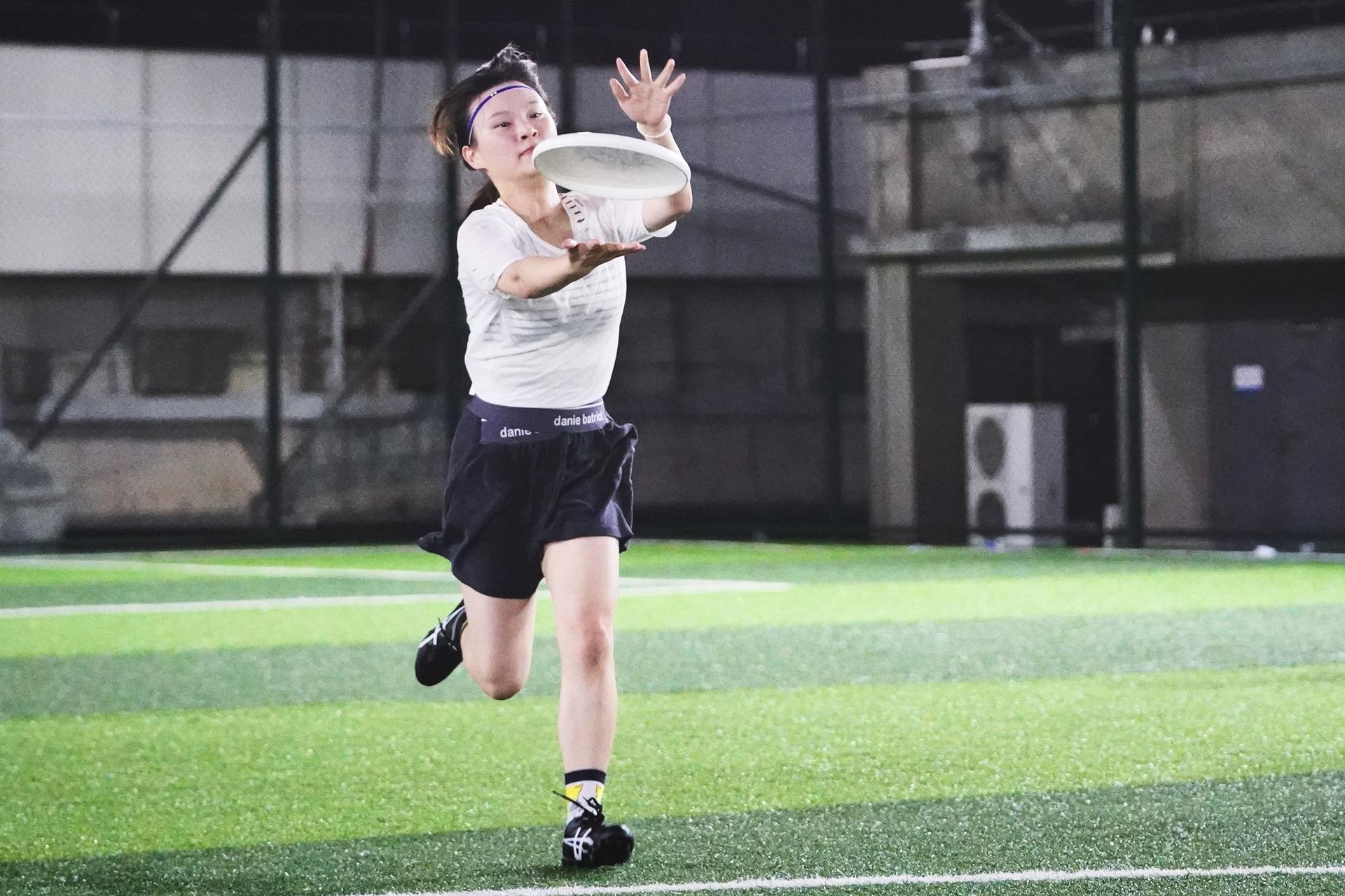 A woman practices Ultimate Frisbee at Shanpo Frisbee Club.