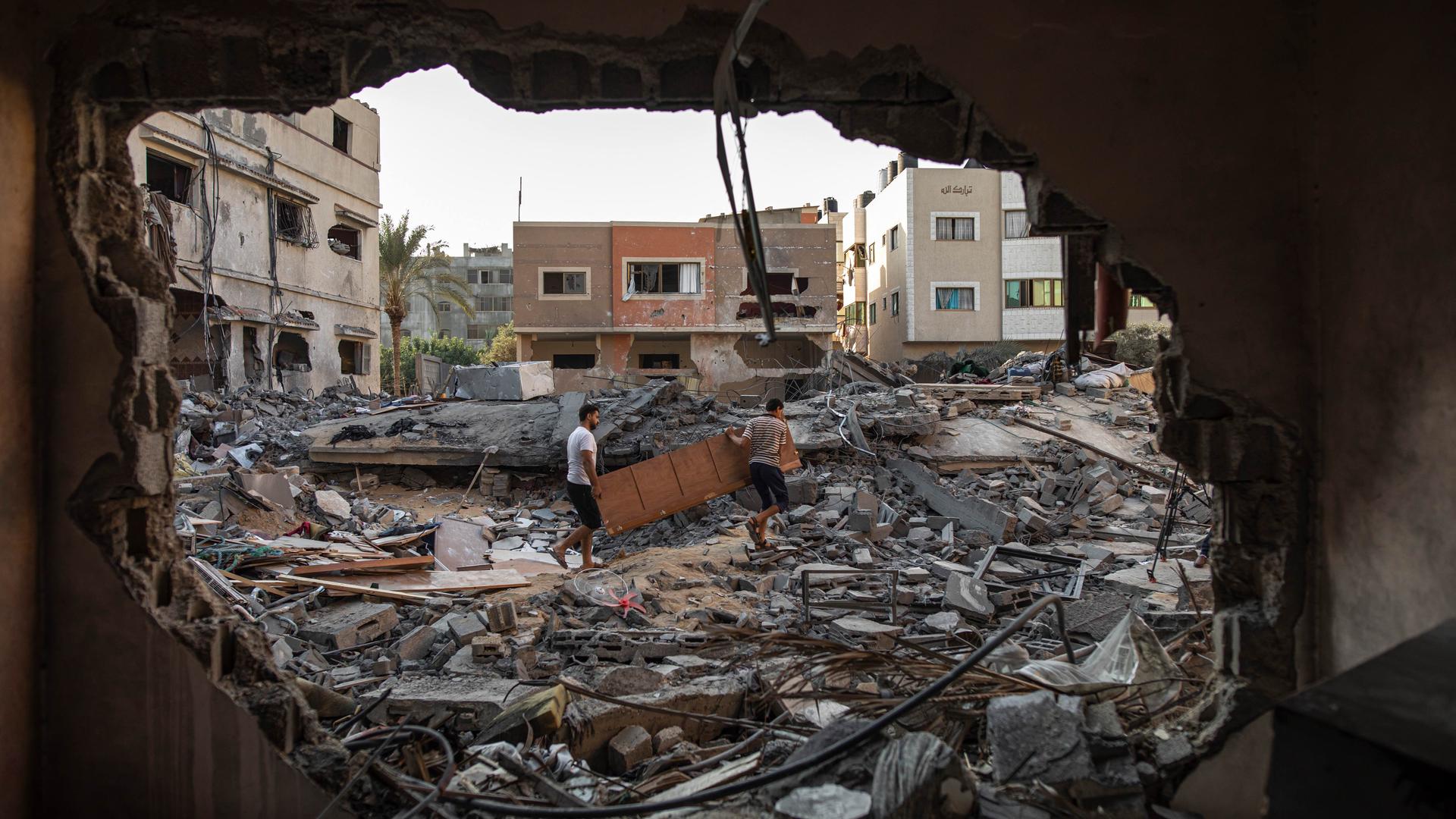 Palestinians inspect their house which was hit by an Israeli airstrike in Gaza City on Aug. 8, 2022. 