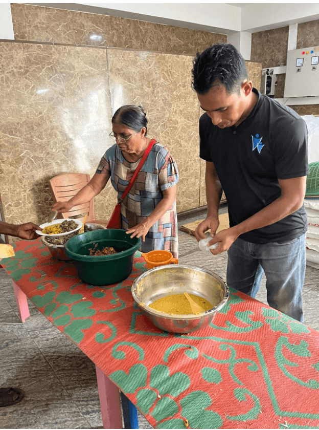 Moses Akash, director of Voice for Voiceless foundation, serves up the last lunch offerings at a community kitchen in Colombo alongside volunteer Irani Kalawa Devage.