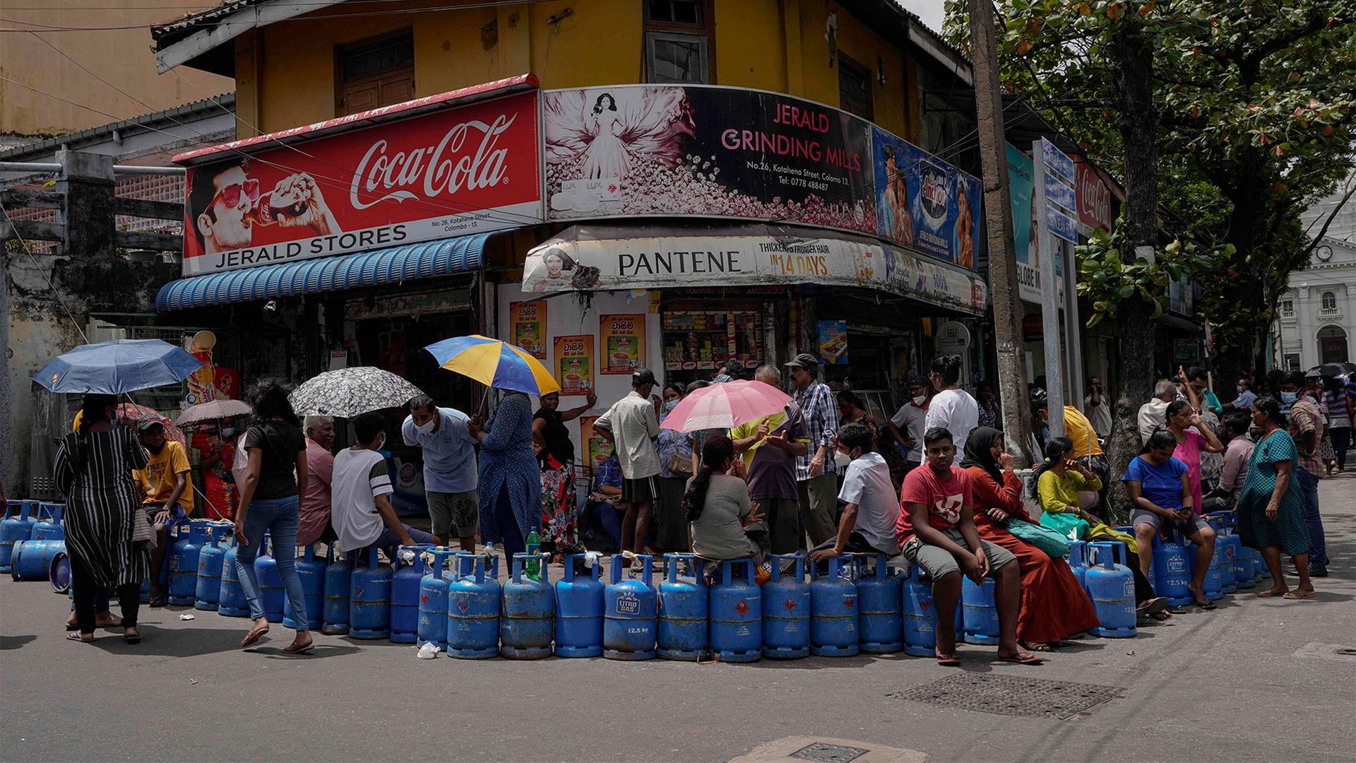 People wait in a queue expecting to buy cooking gas near a distribution center in Colombo, Sri Lanka