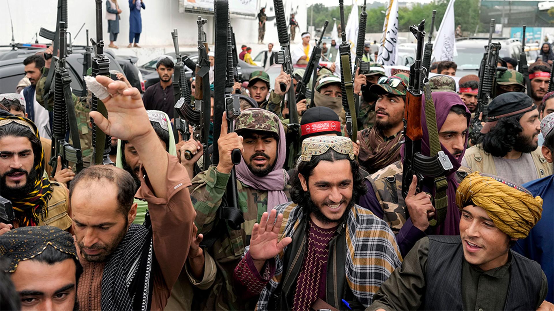 Taliban fighters celebrate one year since they seized the Afghan capital, Kabul, in front of the US Embassy, Kabul, Afghanistan