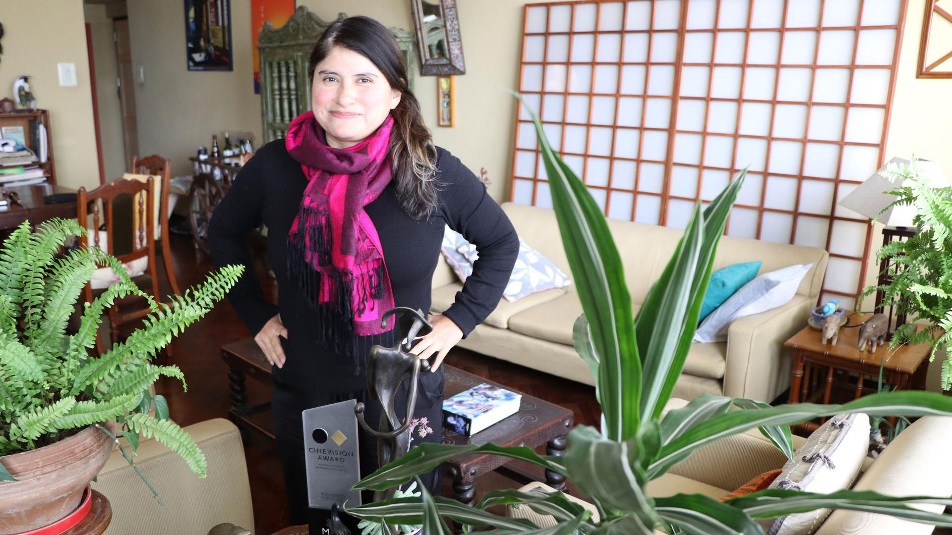 Melina León at her Lima apartment with some of the awards she got for her debut film, “Song Without a Name.”