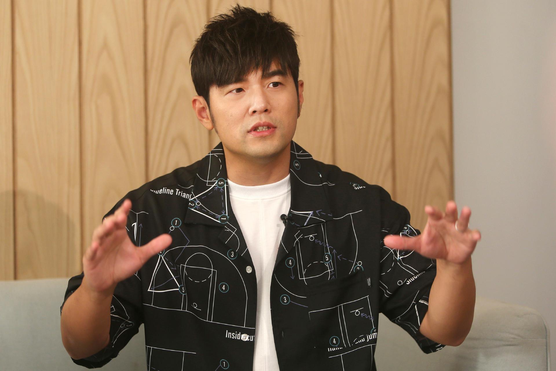 Mandopop superstar Jay Chou gestures while talking about his latest Netflix show 