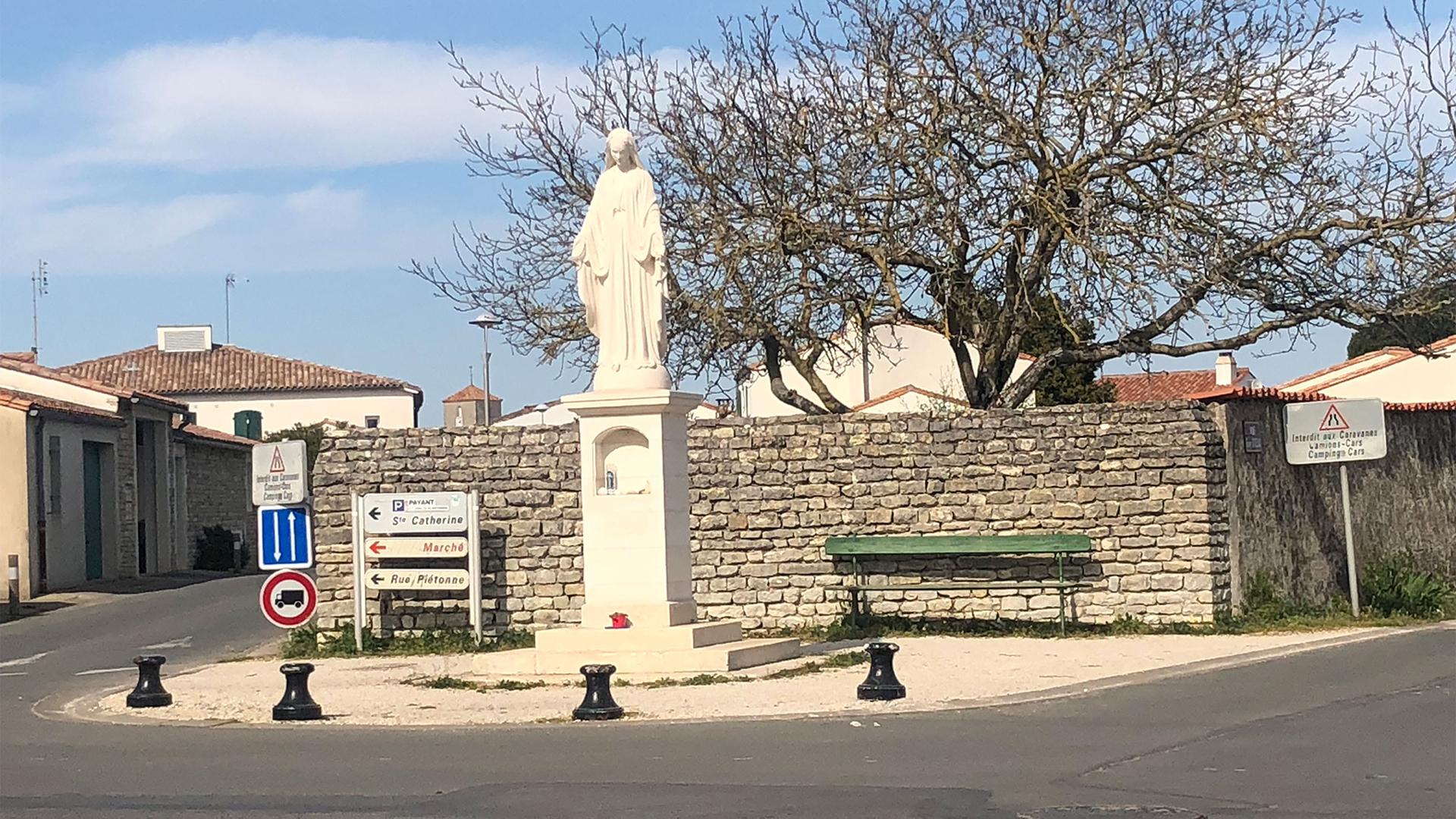 A Virgin Mary statue in a public square in France