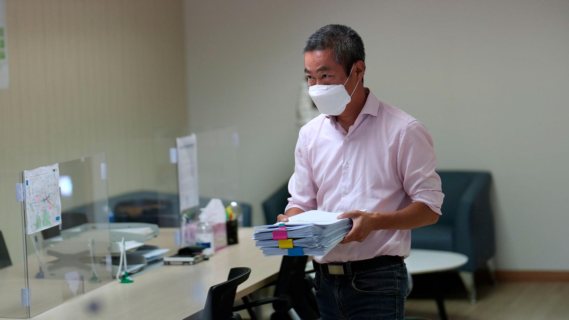 Peter Møller, attorney and co-head of the Danish Korean Rights Group, holds documents at the Truth and Reconciliation Commission in Seoul, South Korea, Tuesday, Aug. 23, 2022. 