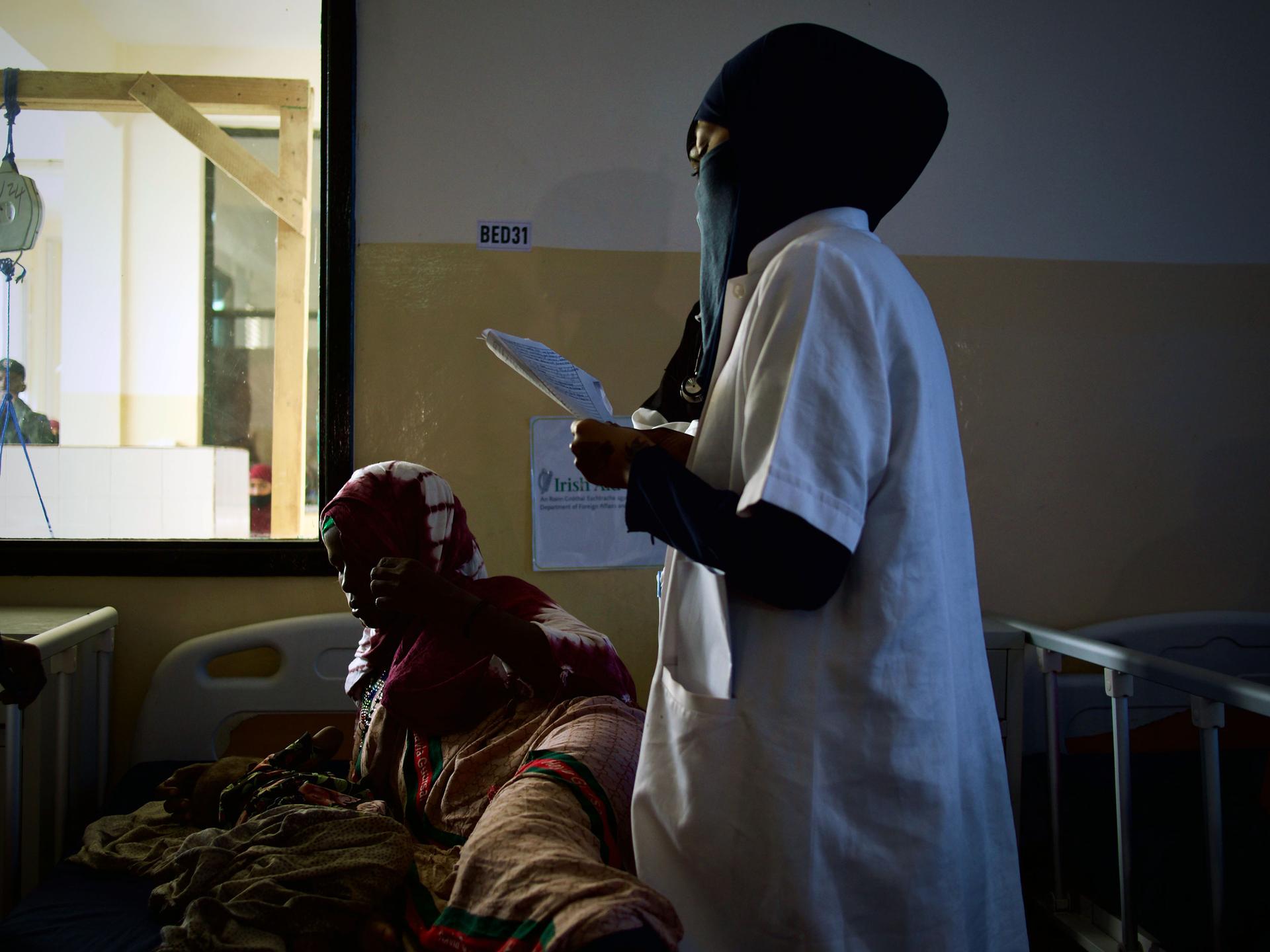 Medical workers speak with a patient at a pediatric ward at Banadir Hospital, Mogadishu, Somalia.