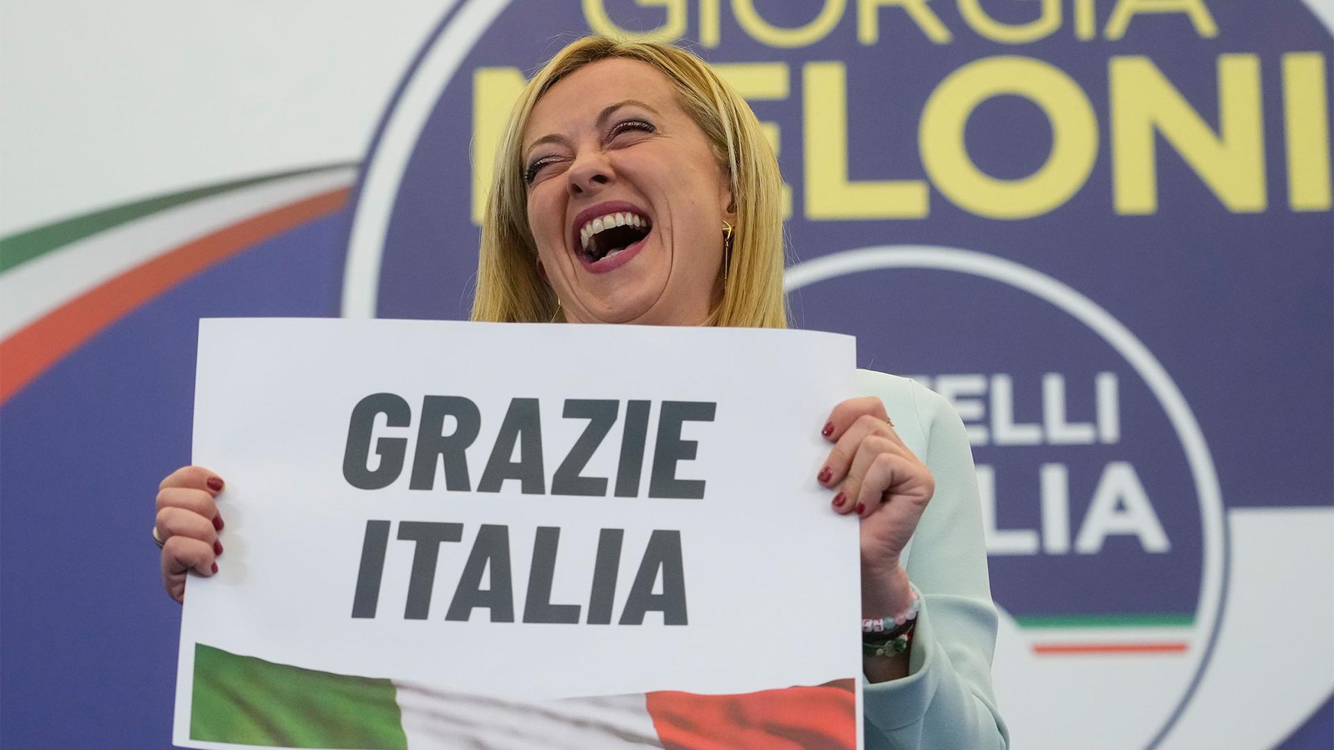 Far-Right party Brothers of Italy's leader Giorgia Meloni shows a placard reading in Italian "Thank you Italy" at her party's electoral headquarters in Rome