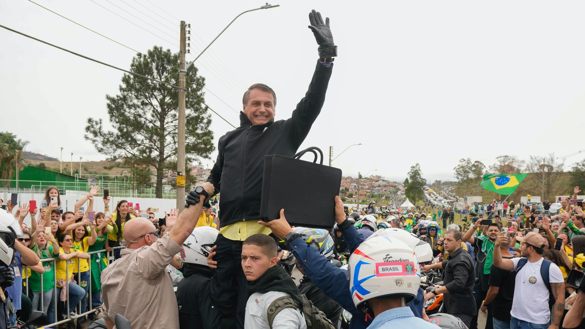 man waving to a crowd 