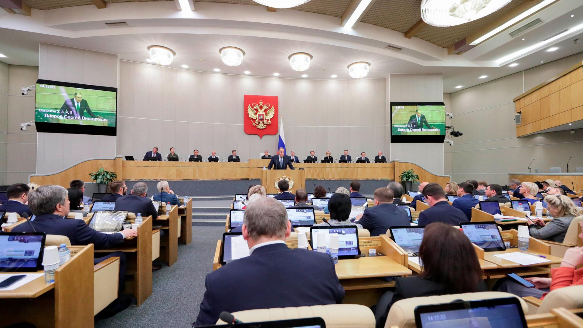 In this handout photo released by The State Duma, The Federal Assembly of The Russian Federation Press Service, Russian Foreign Minister Sergey Lavrov, foreground center, addresses deputies during a session at the State Duma, the Lower House of the Russia