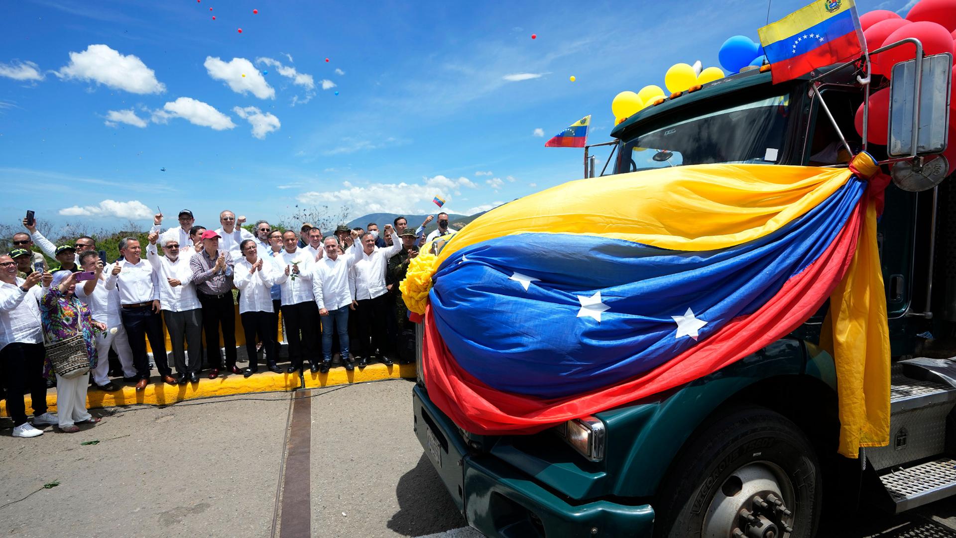 A Venezuelan cargo truck adorned with Venezuelan flags and balloons crosses the Simon Bolivar International Bridge during a ceremony to mark the bridge's reopening to cargo trucks between Cucuta, Colombia, and San Antonio del Tachira, Venezuela