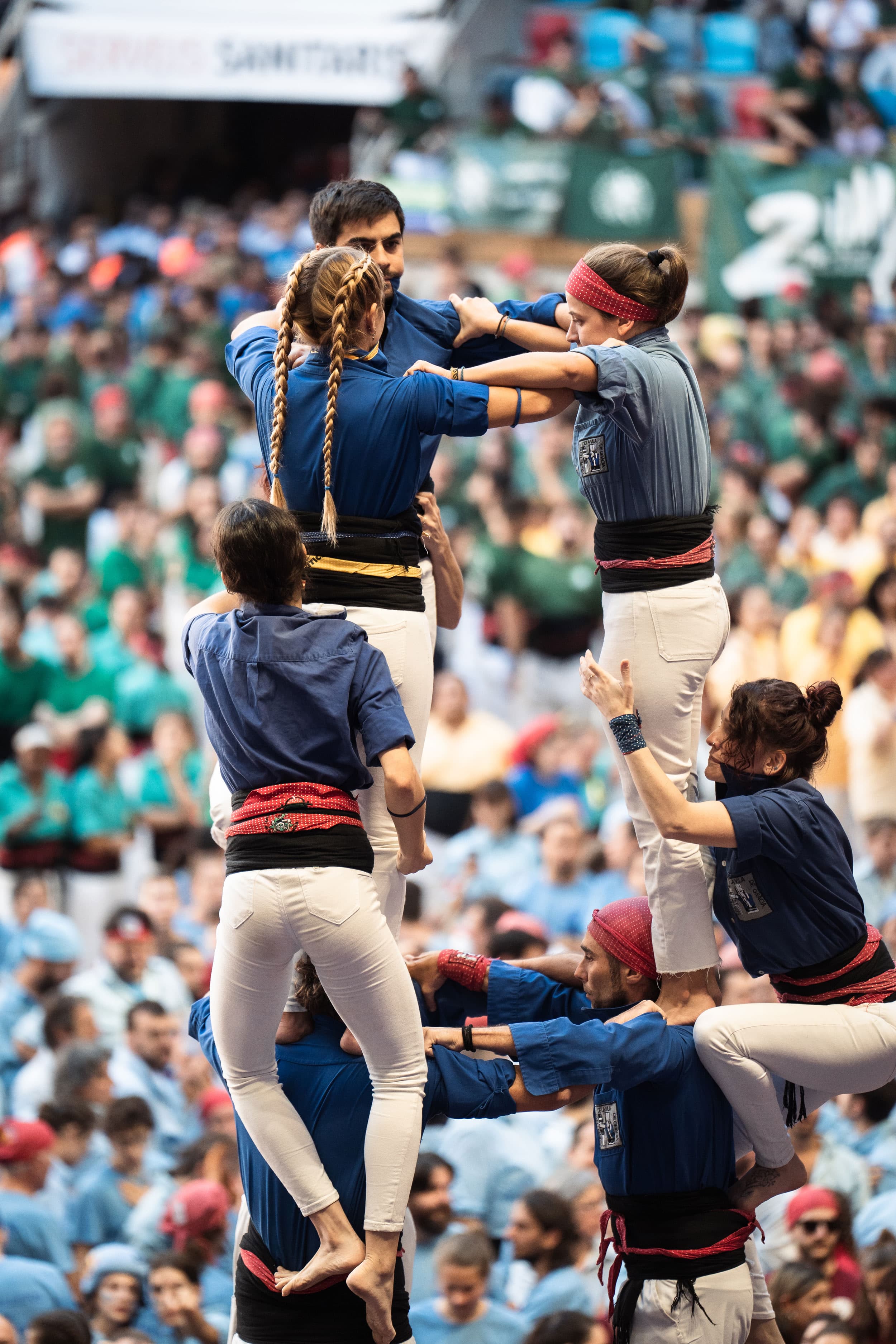 Castellers de la Vila de Gràcia team concentrates on building their tower.
