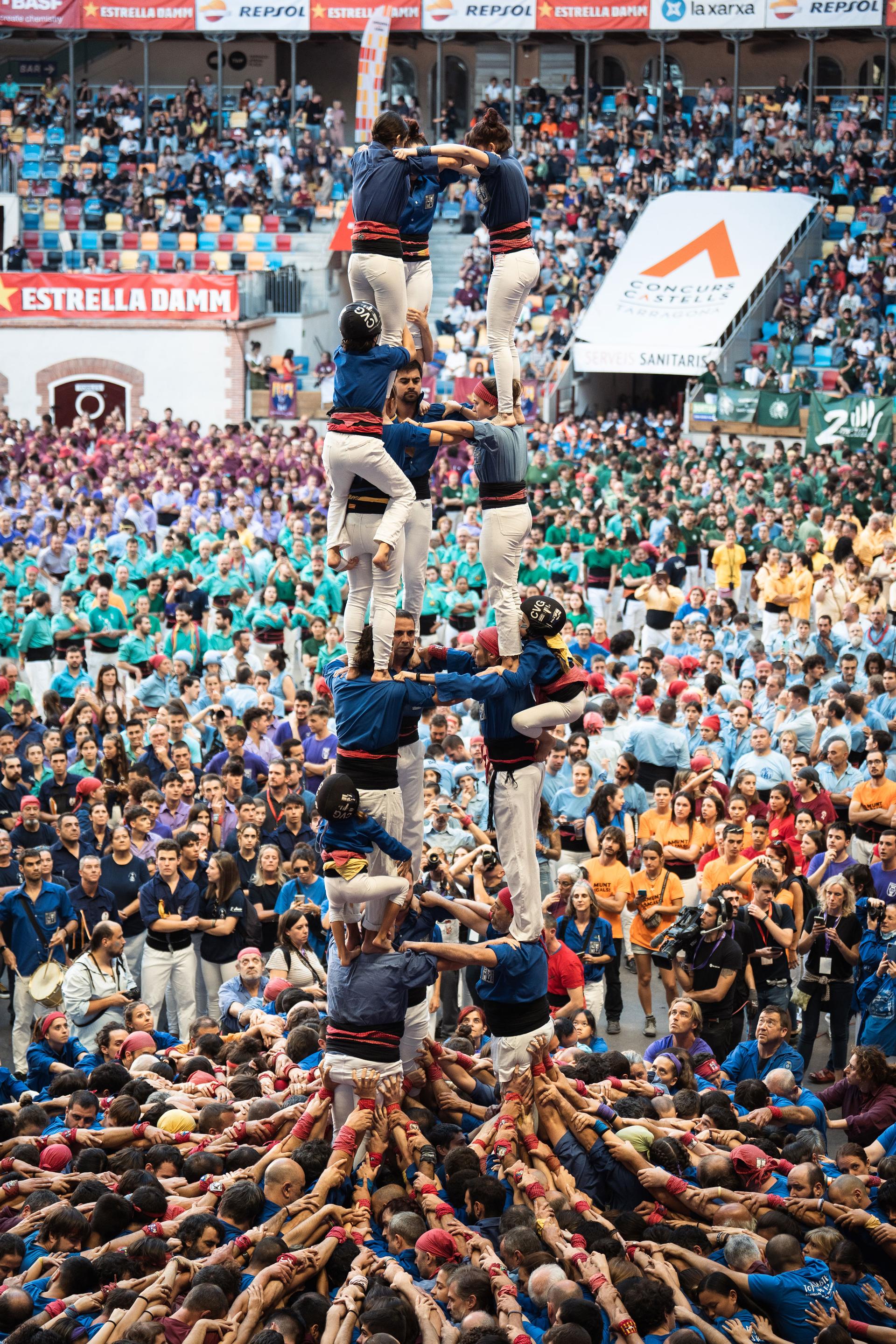 Castellers de la Vila de Gràcia team competes in a human tower competition, with towers reaching up more than 26 feet in the air.