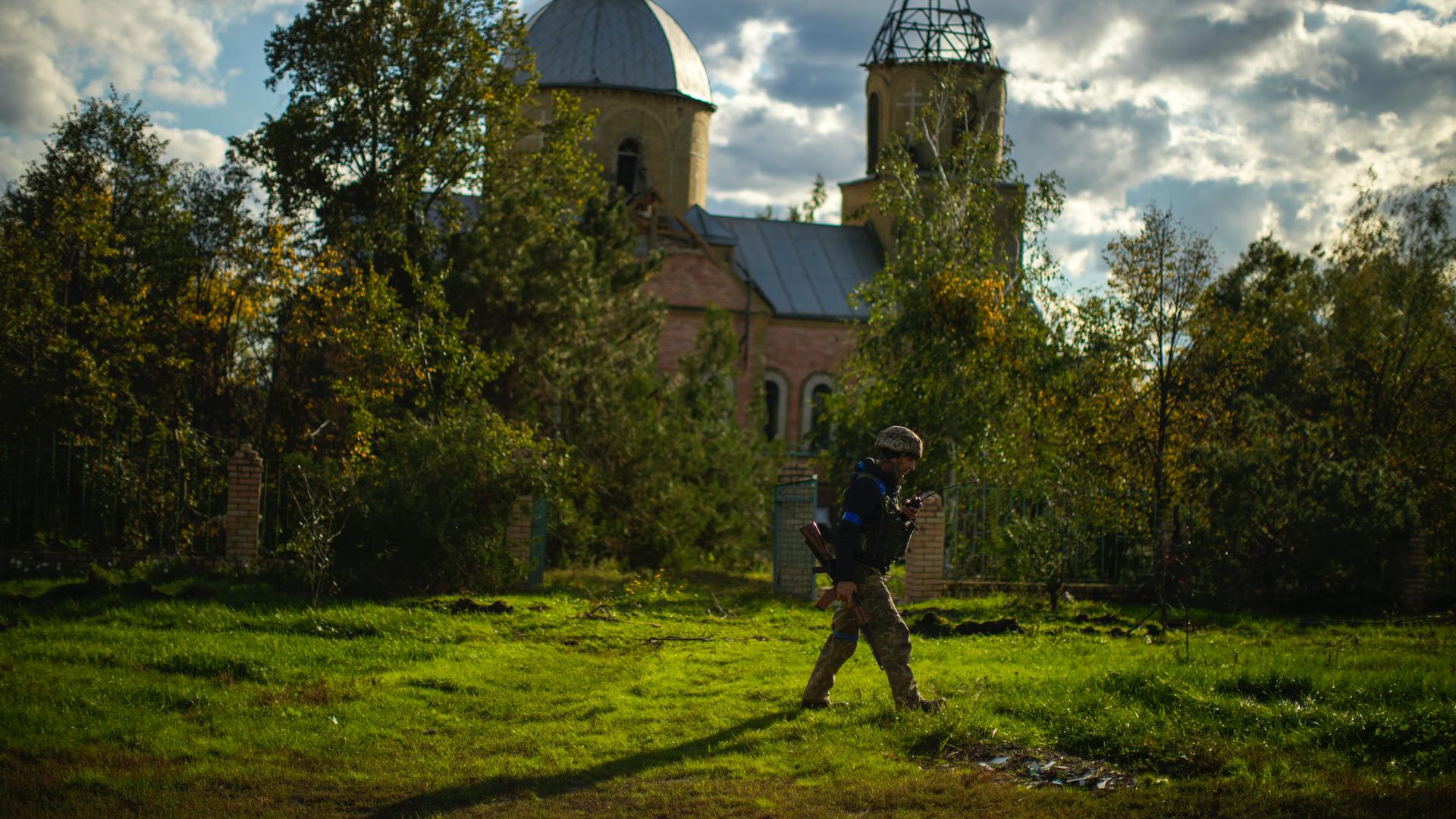 soldier walking past church