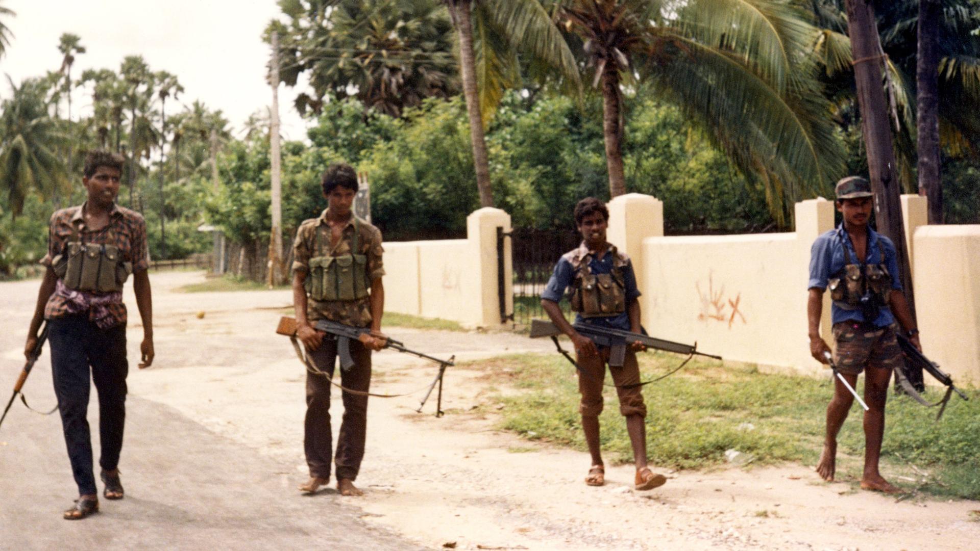 Heavily armed Tamil Tiger rebels walk down a street in Achchuveli village, north east of Jaffna City, Sri Lanka, on Nov. 4, 1987. 