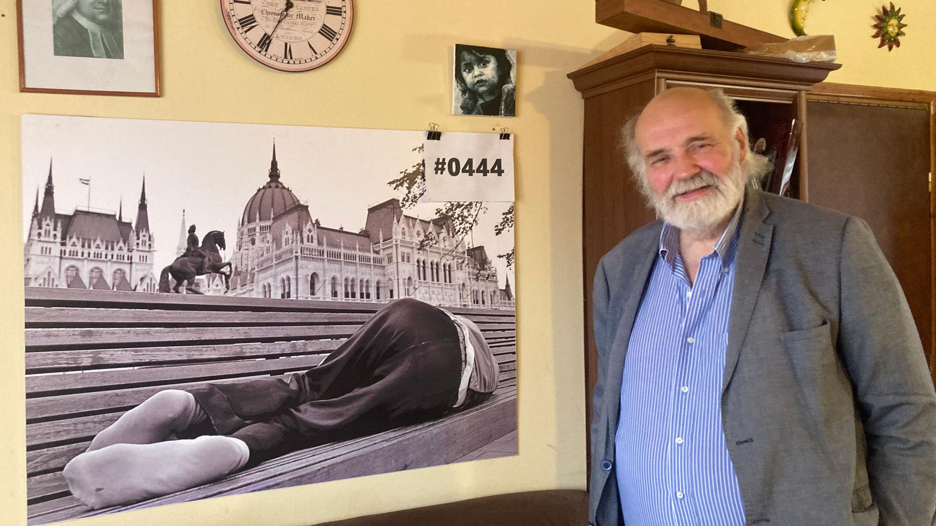 Pastor Gábor Iványi, one of Hungary’s best-known religious leaders, stands in his office near a photograph. 
