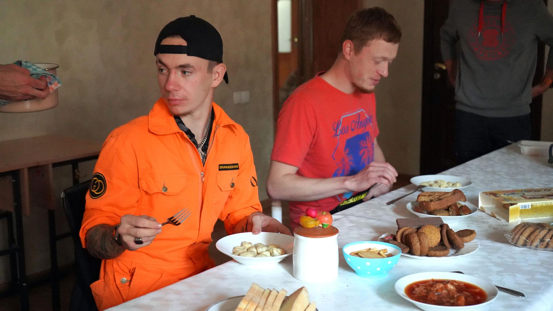 Daniel, a 21-year-old shelter resident from Moscow, sits down for a soup of dumplings and borscht, at the shelter in Almaty.