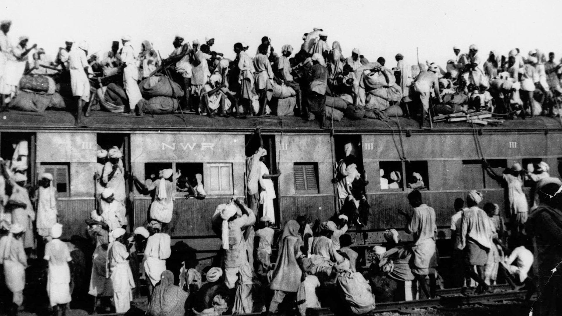 In this September 1947 file photo, hundreds of Muslim refugees crowd on top a train leaving New Delhi for Pakistan. 