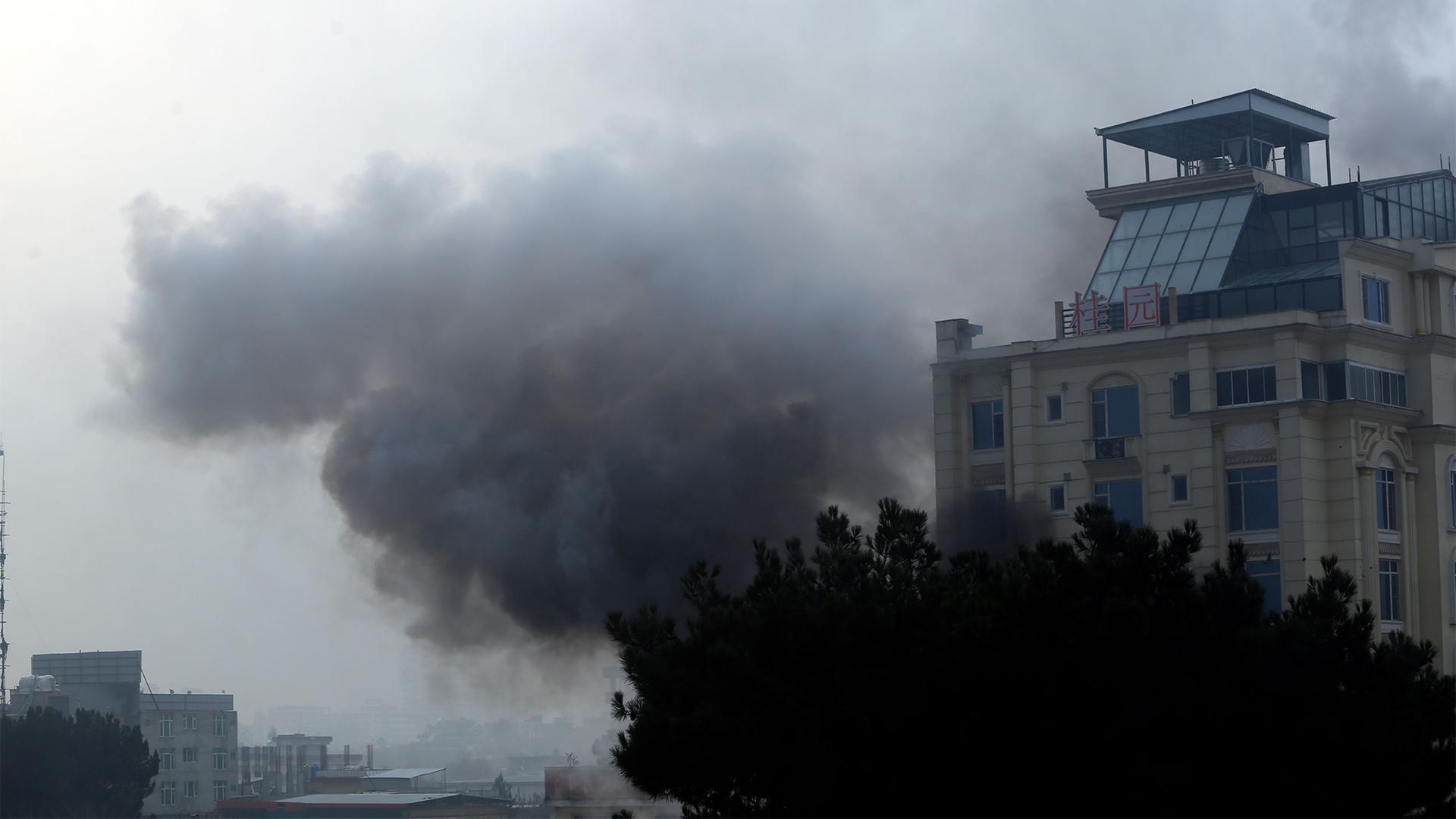 Smoke rises from a hotel building after an explosions and gunfire in Kabul, Afghanistan, Dec. 12, 2022.