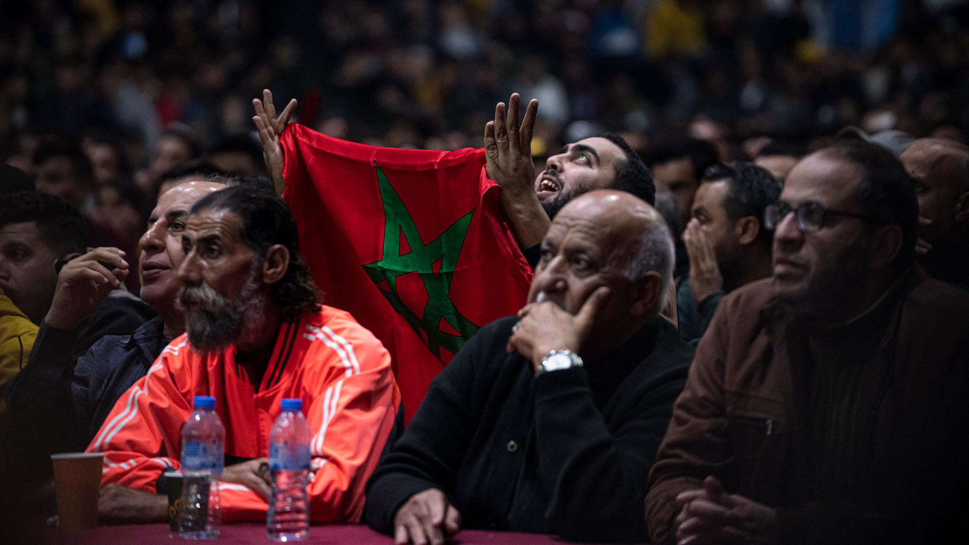 Palestinians react as they watch a live broadcast of the World Cup semifinal soccer match between Morocco and France played in Qatar, in Gaza City, Wednesday, Dec. 14, 2022. 