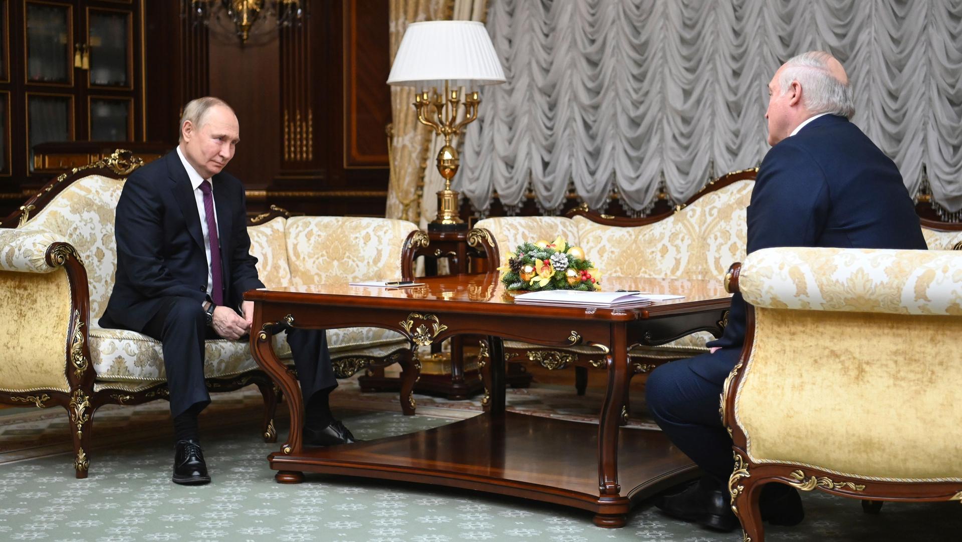 Russian President Vladimir Putin, left, and Belarusian President Alexander Lukashenko talk during their meeting in Minsk, Belarus, Monday, Dec. 19, 2022.