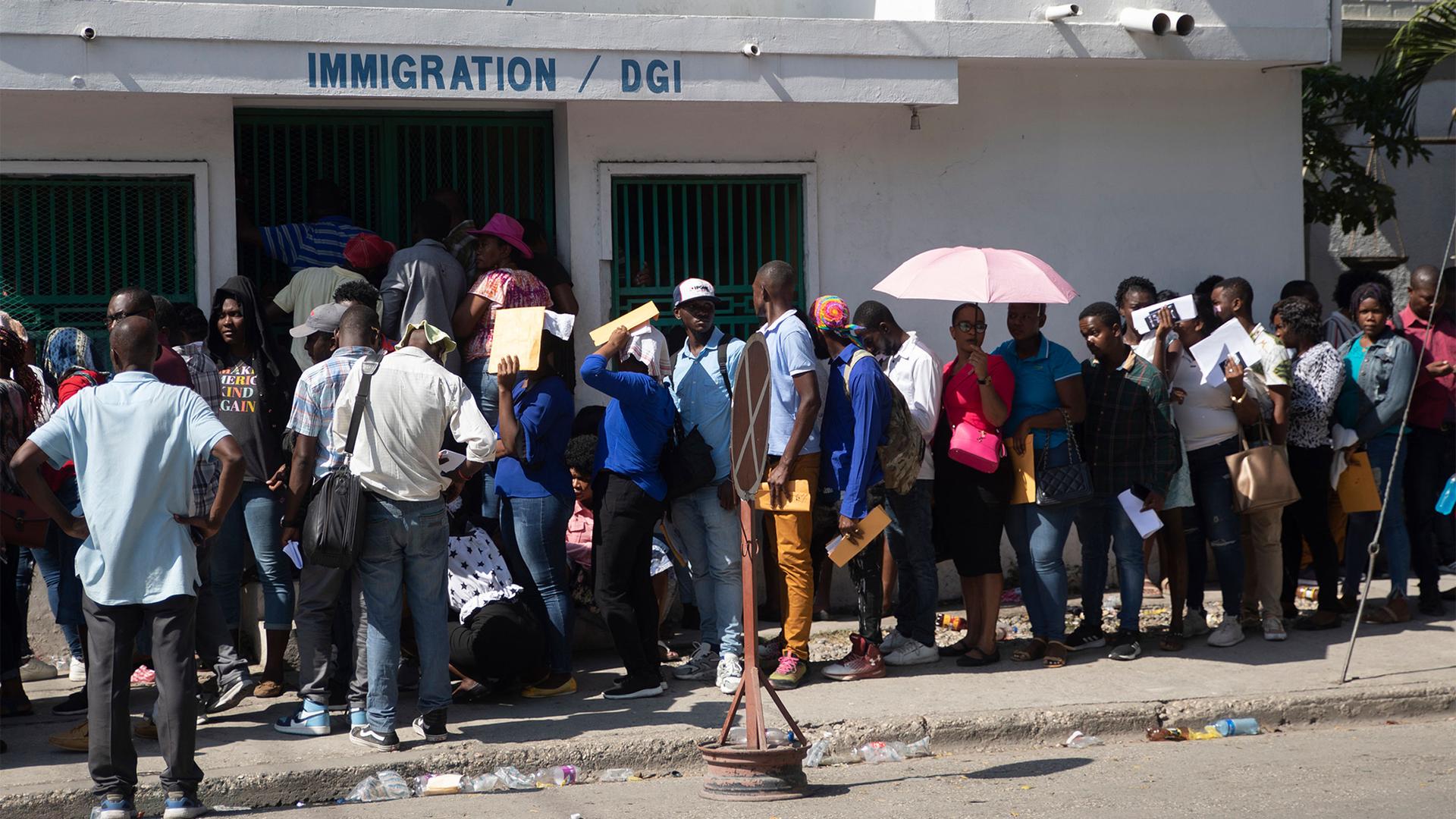 Haitians line up outside an immigration office as they wait their turns to apply for a passport, in Port-au-Prince, Haiti, Jan. 10, 2023.