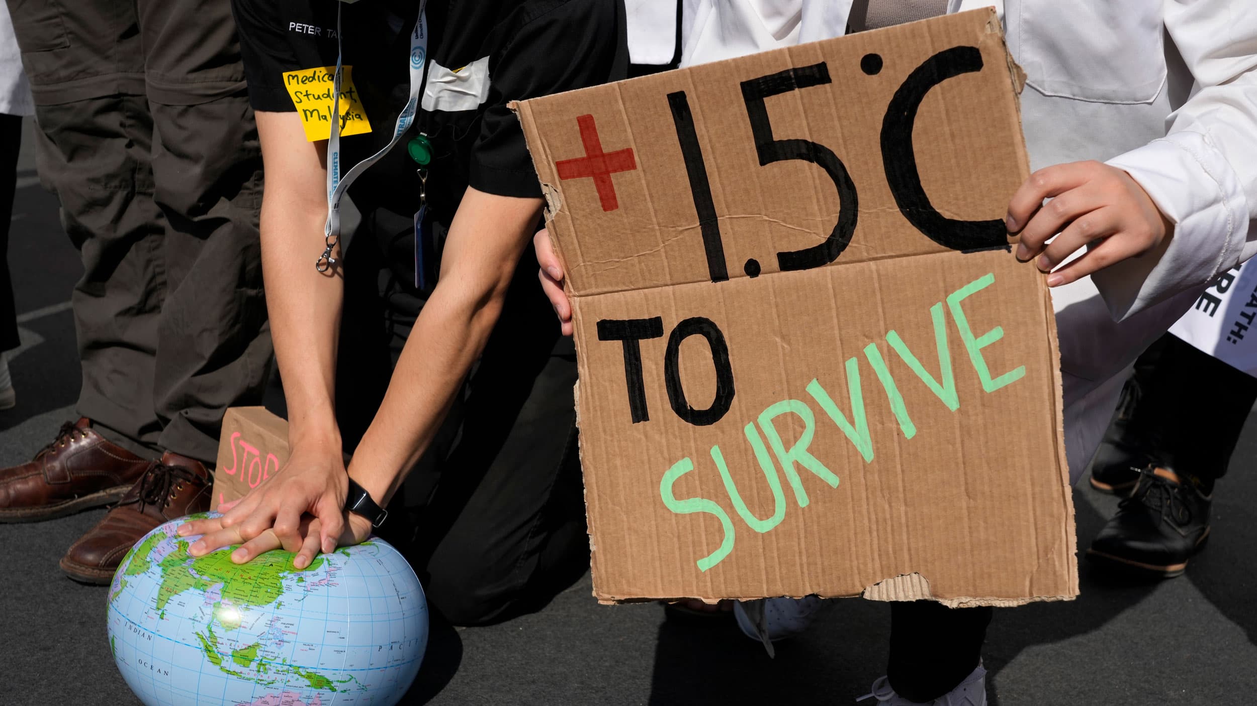 Demonstrators pretend to resuscitate the Earth while advocating for the 1.5 degree warming goal to survive at the COP27 UN Climate Summit, Nov. 16, 2022, in Sharm el-Sheikh, Egypt.