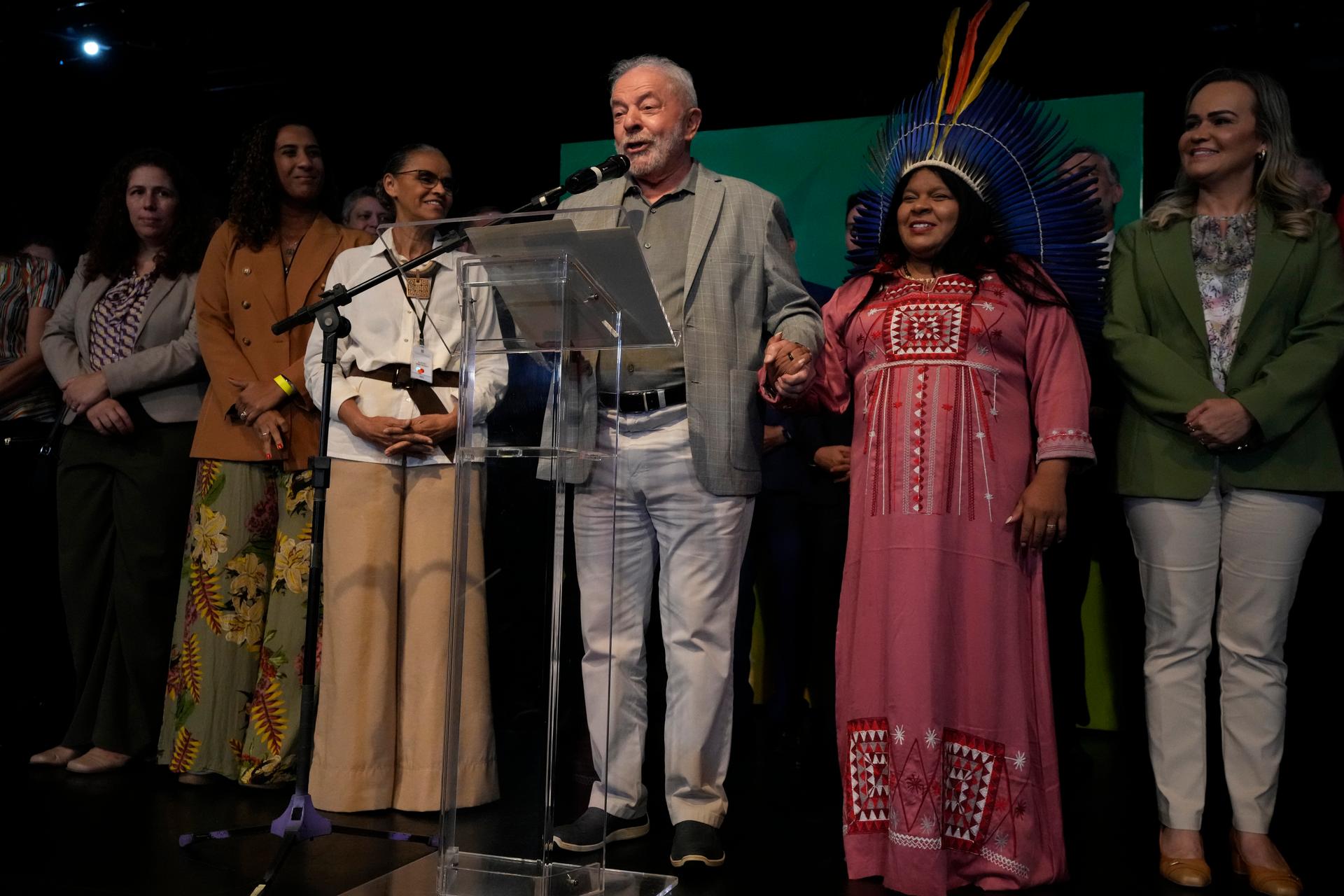 Brazil's President-elect Luiz Inacio Lula da Silva holds the hand of the his newly-named Minister of Indigenous Peoples Sonia Guajajara