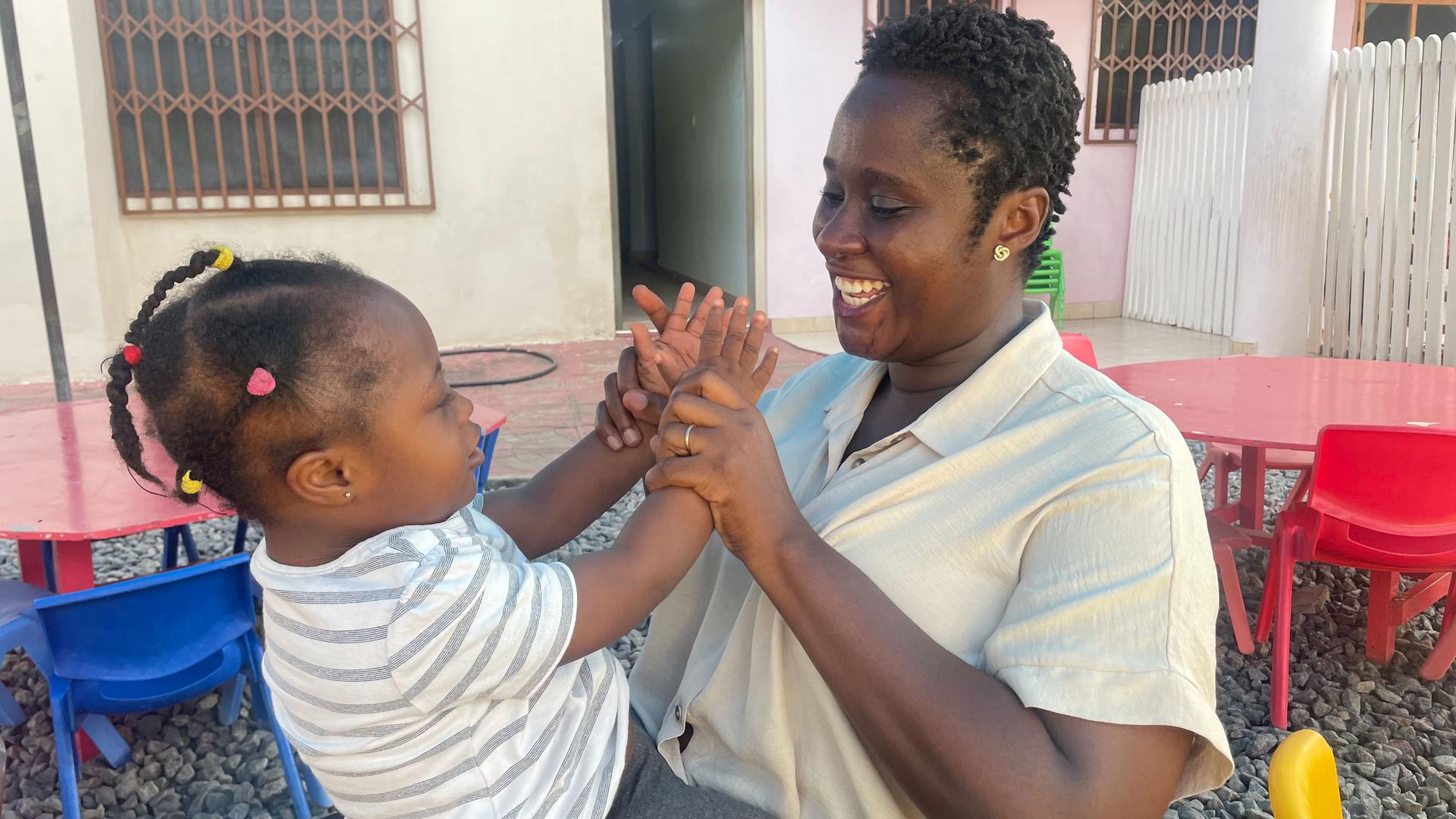Instructor Akua Amoako Yeboah with a child at the early intervention center. 