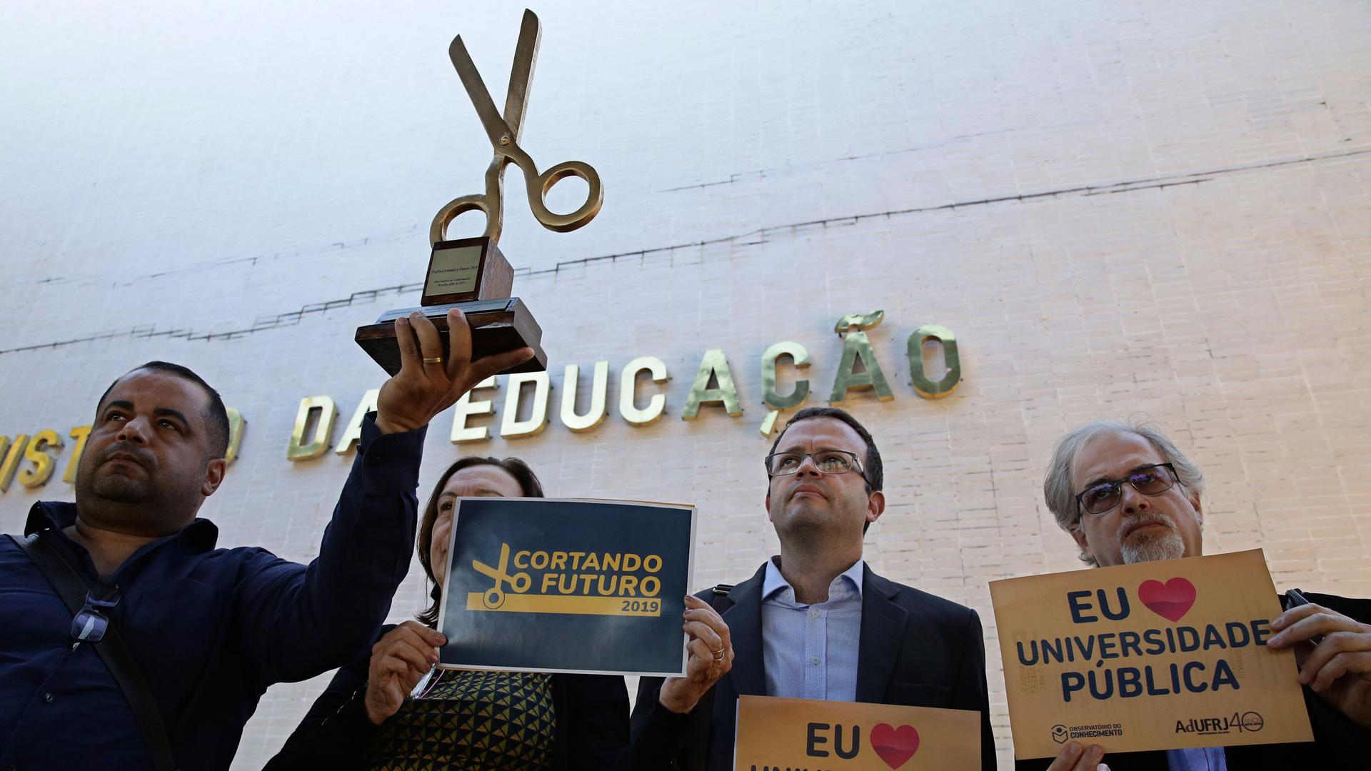 Teachers representing the observatory of knowledge, protest against budget cuts for public universities outside the Ministry of Education, in Brasilia, Brazil, Tuesday, July 2, 2019. 