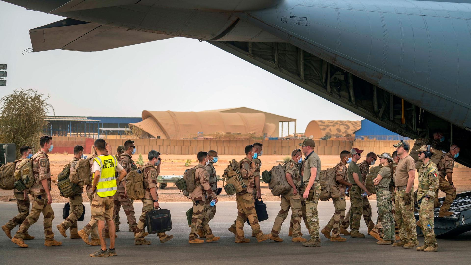 French Barkhane force soldiers who wrapped up a four-month tour of duty in the Sahel board a US Air Force C130 transport plane, leave their base in Gao, Mali, Wednesday June 9, 2021. 